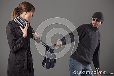 Man mugging woman Stock Photo
