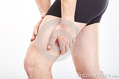 Man muscle strain injury in thigh. Stock Photo