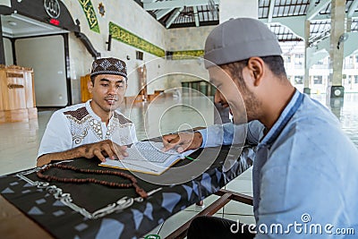 Man muslim learing to reading quran together during ramadan Stock Photo