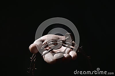 Man with a nail and a crown of thorns Stock Photo