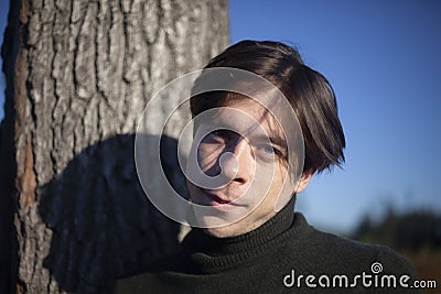 A man in nature. A young man stands in a field. Stock Photo