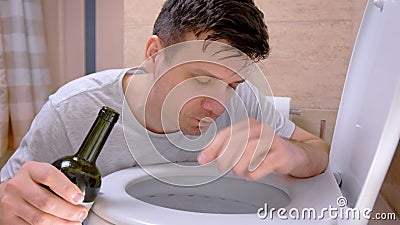Man with Nausea and Vomit in Toilet Feeling Hangover with Wine Bottle in  Hand. Stock Video - Video of nausea, hangover: 160569377