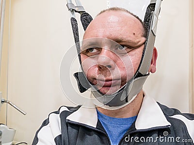 Man in neck traction machine Stock Photo
