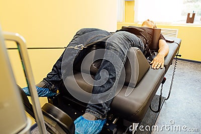 Man at non-surgical spinal decompression procedure Stock Photo