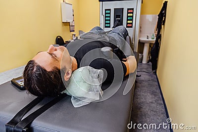 Man at non-surgical spinal decompression procedure Stock Photo