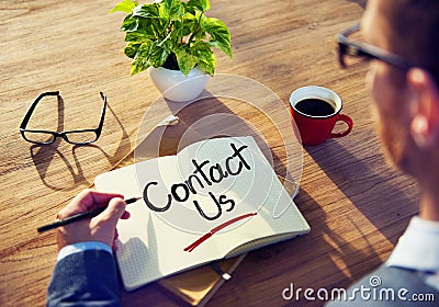 Man with a Note and Contact Us Concept Stock Photo