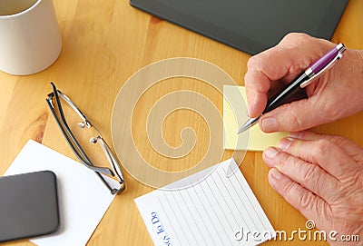 Man with notepads on desk Stock Photo