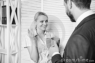 man offer cup of coffee to woman. happy woman talking with boss coffee break. time to have rest. lunch time. corporate Stock Photo