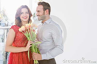 Man offering flower bouquet to woman Stock Photo