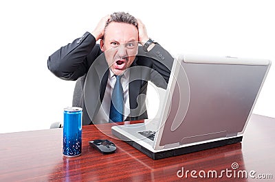 Man at office being psychotic with energy drink aside Stock Photo