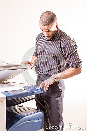 Man in office making copies using photocopier Stock Photo