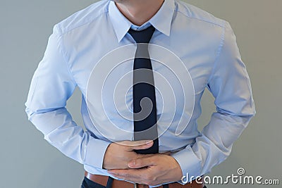 Man in office uniform having a stomachache / food poisoning / st Stock Photo