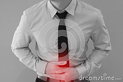 Man in office uniform having a stomachache / food poisoning / stomach problems. Stock Photo