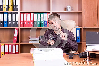 Man in office wipes glasses Stock Photo