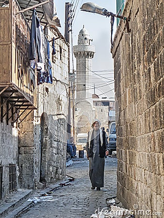 Man in old town street of aleppo syria Editorial Stock Photo