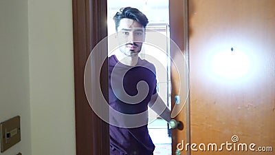 Man opening door and inviting Stock Photo