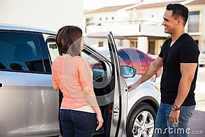 Man opening door to woman Stock Photo