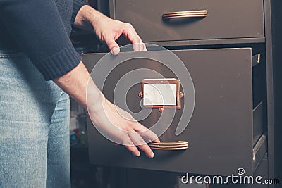 Man opening file cabinet Stock Photo