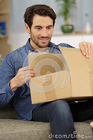 man opening fragile parcel Stock Photo
