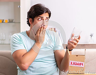 Man opening fragile parcel ordered from internet Stock Photo