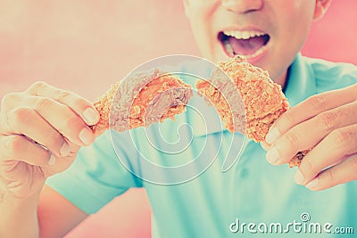 A man with opening mouth about to eat deep fried chicken legs Stock Photo