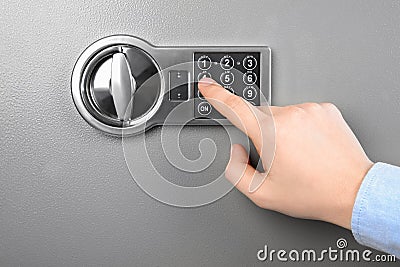 Man opening steel safe with electronic combination lock, closeup Stock Photo
