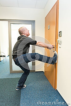 Man opens the door force Stock Photo