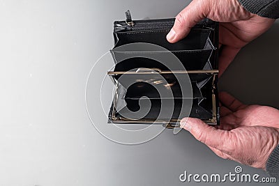 Man opens and holding empty wallet with some coins. money is over due to quarantine Stock Photo