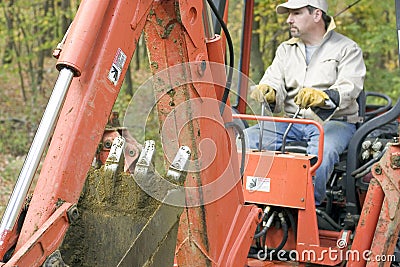 Man Operating Backhoe Stock Photo