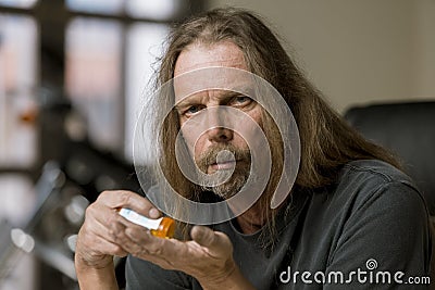 Man with an Opioid Prescription Pill Bottle Stock Photo