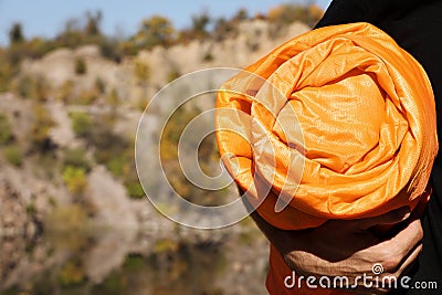 Man with orange sleeping bag outdoors, closeup. Stock Photo