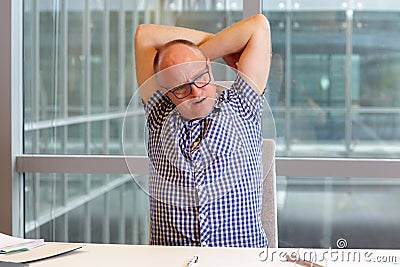 Man with pain in the neck stretching arms Stock Photo