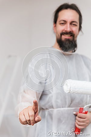 Man with painter roller is interacting Stock Photo