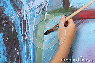 Man painting blue abstract picture Stock Photo