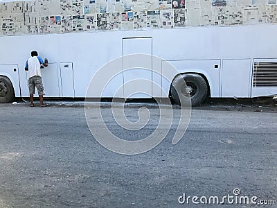 Man Painting white bus Editorial Stock Photo