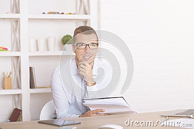 Man with paperwork thinking Stock Photo