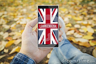 man in the park learn english smartphone Stock Photo