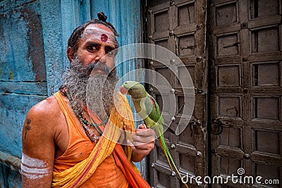 Man with parrot, Varanasi, India Editorial Stock Photo