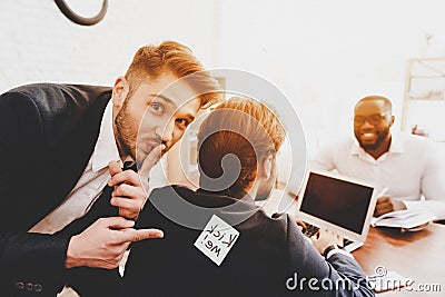 Man Pasted Sticker on Back of Colleague in Office. Stock Photo