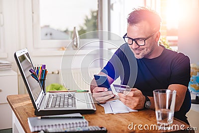 Man paying with credit card on smart phone Stock Photo