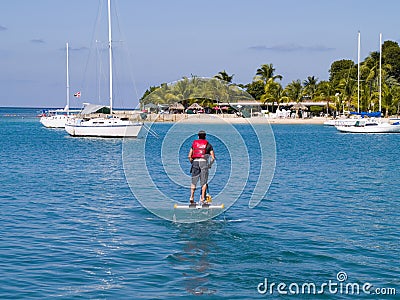 Man on peddle boat in tropics Stock Photo