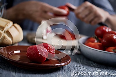 Man peeling scalded tomatoes Stock Photo