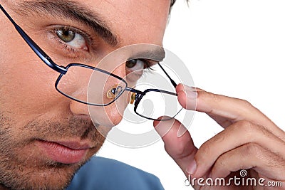 Man peering over his glasses Stock Photo