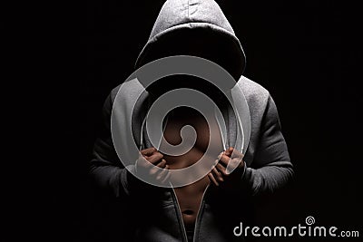 Man with perfect body opens his hoodie and shows his trained abdominal muscles. Fitness, workout and training concept Stock Photo