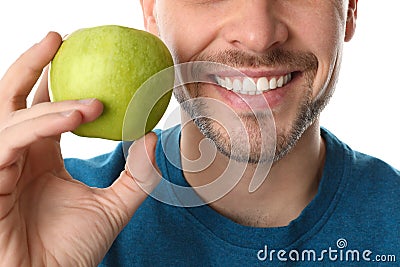 Man with perfect teeth and green apple on white background Stock Photo