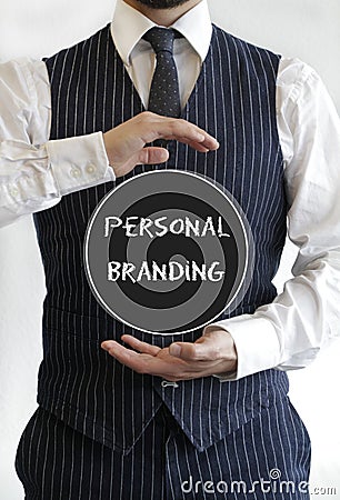 Man with a personal branding text on a black circle in the middle of his hands Stock Photo