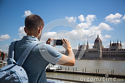 man photographs the building of the Hungarian parliament Editorial Stock Photo