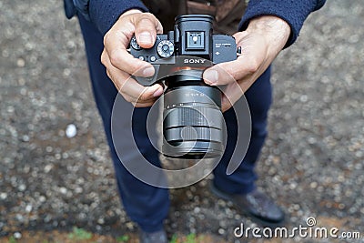 A man photographs with a Sony Alpha R III Editorial Stock Photo