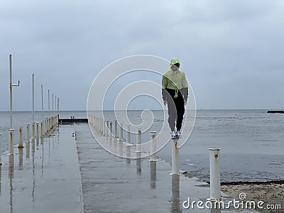 Man on a pier on a rainy day Stock Photo