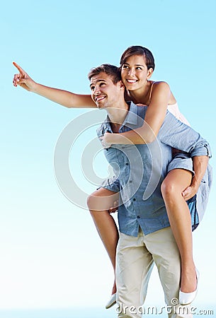 Man piggybacking woman. Portrait of handsome man giving piggyback ride to woman. Stock Photo